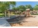 Community playground with slides, climbing area, and shaded seating for neighborhood families to enjoy at 18542 W Valerie Dr, Surprise, AZ 85374
