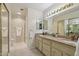 Neutral toned bathroom featuring dual sinks, vanity lighting, and glass enclosed shower at 2055 N 56Th St # 15, Mesa, AZ 85215