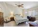 Light and airy bedroom features a ceiling fan, carpeted floors, and natural light from the windows at 2055 N 56Th St # 15, Mesa, AZ 85215