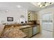 Open kitchen area with granite countertops, neutral backsplash, and cabinetry with views to the living room at 2055 N 56Th St # 15, Mesa, AZ 85215