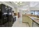 A bright kitchen features tile flooring, appliances, and neutral-toned cabinets and countertops at 2055 N 56Th St # 15, Mesa, AZ 85215