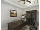 Home office features a ceiling fan, built-in display cabinet, and desk and chair at 2055 N 56Th St # 15, Mesa, AZ 85215
