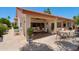Charming covered patio with dining and lounge seating, perfect for outdoor entertaining and relaxation at 2055 N 56Th St # 15, Mesa, AZ 85215