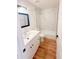 Bright bathroom featuring a tub with marble tile and a vanity with modern fixtures at 225 N Standage -- # 45, Mesa, AZ 85201