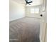 A bright, carpeted bedroom features a ceiling fan and window offering great natural light in a modern home at 225 N Standage -- # 45, Mesa, AZ 85201