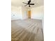 A spacious carpeted bedroom features a ceiling fan, with a door to the bathroom at 225 N Standage -- # 45, Mesa, AZ 85201