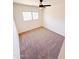 Bedroom featuring carpet, a ceiling fan, and large window for natural light at 225 N Standage -- # 45, Mesa, AZ 85201