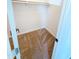 A small closet with neutral carpet flooring and a single shelf offers practical storage solutions at 225 N Standage -- # 45, Mesa, AZ 85201