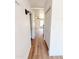 Hallway with light wood flooring, light fixtures and white closet doors at 225 N Standage -- # 45, Mesa, AZ 85201