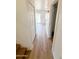 Hallway showcasing wood floors that leads into the living space and laundry area at 225 N Standage -- # 45, Mesa, AZ 85201