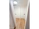 Hallway with wood floors that leads to two white doors and a view of the stairs at 225 N Standage -- # 45, Mesa, AZ 85201