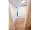 Hallway with light wood flooring, closets, and bright white walls at 225 N Standage -- # 45, Mesa, AZ 85201