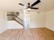Bright living area features staircase, ceiling fan, and open view to kitchen area at 225 N Standage -- # 45, Mesa, AZ 85201