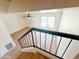 Staircase with black railings leads to a bright, open living space featuring hardwood floors and a large window at 225 N Standage -- # 45, Mesa, AZ 85201