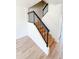 Staircase with wood steps and dark metal railing, offering a stylish and functional design at 225 N Standage -- # 45, Mesa, AZ 85201