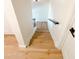 The staircase features wood treads and white risers with black metal railings at 225 N Standage -- # 45, Mesa, AZ 85201