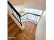 Hardwood staircase with sleek black railing leads to an open floor plan in this modern, stylish home at 225 N Standage -- # 45, Mesa, AZ 85201