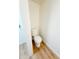 Small powder room with white toilet and light wood floors at 225 N Standage -- # 45, Mesa, AZ 85201