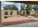 Desert backyard with rock groundcover, trimmed hedges, and block wall fencing at 23317 N Arrellaga Dr, Sun City West, AZ 85375