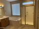Bright bathroom with a soaking tub, a glass-enclosed shower, and tile flooring at 23317 N Arrellaga Dr, Sun City West, AZ 85375
