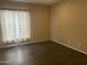 Bedroom features wood floors and a window with curtains at 23317 N Arrellaga Dr, Sun City West, AZ 85375