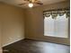 Bedroom featuring wood flooring, a ceiling fan, and a window with blinds and curtains at 23317 N Arrellaga Dr, Sun City West, AZ 85375