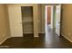 Bedroom with wood flooring, closet with sliding doors, and an open doorway to another room at 23317 N Arrellaga Dr, Sun City West, AZ 85375