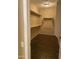 A walk-in closet featuring multiple shelves and a dark wood floor adds organized storage at 23317 N Arrellaga Dr, Sun City West, AZ 85375