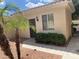 Tan home exterior with palm trees and meticulous landscaping at 23317 N Arrellaga Dr, Sun City West, AZ 85375