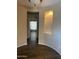 Spacious living room featuring wood-look tile floors, neutral colors, and recessed display nook at 23317 N Arrellaga Dr, Sun City West, AZ 85375