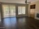 Bright living room with wood-look tile flooring, sliding glass doors, built-in shelving and ceiling fan at 23317 N Arrellaga Dr, Sun City West, AZ 85375