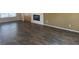 Living room featuring wood-look tile flooring, fireplace, and built-in shelving at 23317 N Arrellaga Dr, Sun City West, AZ 85375