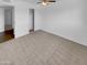 Well-lit bedroom with carpet, ceiling fan, and closet at 2614 E Obregon St, Tempe, AZ 85288
