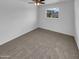 Carpeted bedroom with neutral decor and bright window for natural light at 2614 E Obregon St, Tempe, AZ 85288