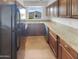 Galley kitchen with granite countertops and stainless steel appliances at 2614 E Obregon St, Tempe, AZ 85288