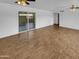 Large living room featuring wood-look flooring, bright light and backyard access at 2614 E Obregon St, Tempe, AZ 85288