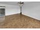 Bright living room with wood-look floors, ceiling fan, and fresh white paint at 2614 E Obregon St, Tempe, AZ 85288