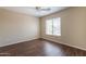 Bedroom features neutral walls, a ceiling fan, and wood-look floors creating a serene space at 33055 N Madison Way Dr, San Tan Valley, AZ 85144