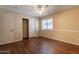 Bedroom with fan, closet, and window features wood-look floors and neutral wall tones at 33055 N Madison Way Dr, San Tan Valley, AZ 85144