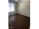 Cozy bedroom with wood flooring, a bright window, and a ceiling fan at 33055 N Madison Way Dr, San Tan Valley, AZ 85144