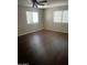 Cozy bedroom with two windows and wood flooring at 33055 N Madison Way Dr, San Tan Valley, AZ 85144