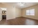 Cozy bedroom features wood-look floors, a ceiling fan, and a large window for natural light and outdoor views at 33055 N Madison Way Dr, San Tan Valley, AZ 85144