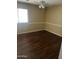 This bedroom features wood floors, a ceiling fan, and bright natural light at 33055 N Madison Way Dr, San Tan Valley, AZ 85144