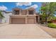 Charming two-story home with a three car garage and well-maintained front yard at 33055 N Madison Way Dr, San Tan Valley, AZ 85144