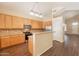 Open kitchen with wooden cabinets, stainless steel appliances, and a breakfast bar at 33055 N Madison Way Dr, San Tan Valley, AZ 85144