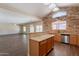 Bright kitchen featuring wood cabinets, stainless steel appliances, and a stone accent wall for added charm at 33055 N Madison Way Dr, San Tan Valley, AZ 85144