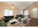 Cozy living room features stylish furniture, hardwood floors, and vaulted ceilings at 33055 N Madison Way Dr, San Tan Valley, AZ 85144