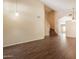 Open-concept living room with hardwood floors, staircase access, and plenty of natural light at 33055 N Madison Way Dr, San Tan Valley, AZ 85144