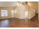 Spacious living room boasts hardwood floors, vaulted ceilings, and staircase access at 33055 N Madison Way Dr, San Tan Valley, AZ 85144