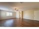 A spacious living room features wood floors, a ceiling fan, and natural light at 33055 N Madison Way Dr, San Tan Valley, AZ 85144